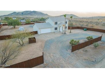 A two-story home featuring desert landscaping and an attached two car garage at 1819 W Joy Ranch Rd, Phoenix, AZ 85086