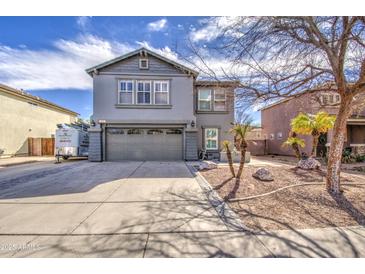 Charming two-story home with gray stucco, a two-car garage, and desert landscaping in the front yard at 2607 W Ironstone Ave, Apache Junction, AZ 85120