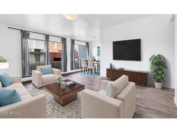 Bright living room with hardwood floors, modern furniture, and large windows offering natural light at 3500 N Hayden Rd # 2201, Scottsdale, AZ 85251