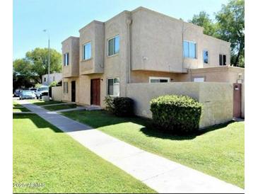 Two-story stucco home with walkway, lawn, and mature landscaping at 5420 W Lynwood St, Phoenix, AZ 85043