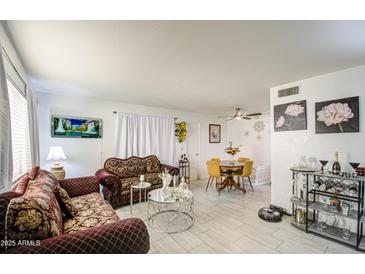 Inviting living room featuring stylish seating, tile floors, and ample natural light at 5962 W Townley Ave, Glendale, AZ 85302