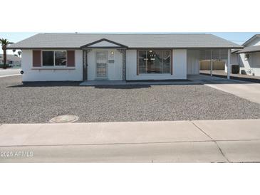 Charming single story home with white exterior and desert landscaping at 9923 W Hope N Cir, Sun City, AZ 85351