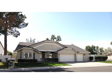 Charming single-story home featuring a well-manicured lawn and a spacious three-car garage at 1119 E Southshore Dr, Gilbert, AZ 85234