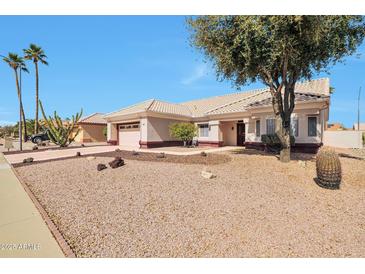 Charming single-story home with desert landscaping, a two-car garage and a cozy front porch at 14936 W Yosemite Dr, Sun City West, AZ 85375