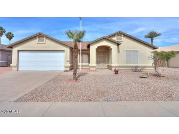 Charming single-story home featuring a two-car garage, desert landscaping, and a welcoming front entrance at 1668 E Valerie St, Casa Grande, AZ 85122