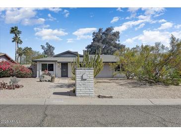 Charming single-story home featuring a desert landscaped front yard and brick mailbox at 17801 N 43Rd Way, Phoenix, AZ 85032