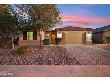 Charming single-story home featuring a tile roof, desert landscaping, and a two-car garage at 19797 W Lincoln St, Buckeye, AZ 85326