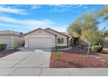 Charming single-story home featuring a well-manicured yard and a two-car garage, perfect for suburban living at 44321 Cypress Ln, Maricopa, AZ 85138