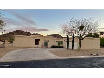 Lovely single-story home boasts a circle drive and lush desert landscaping at 4525 E Onyx Ave, Phoenix, AZ 85028