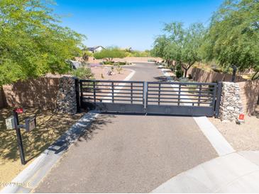 A private gate entry leads to this meticulously landscaped desert home with mature trees and desert flora at 5237 E Montgomery E Rd, Cave Creek, AZ 85331