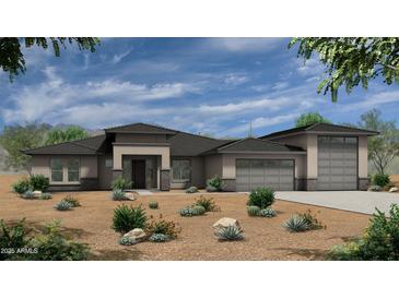 A modern single-story home featuring neutral stucco, stone accents, desert landscaping, and a three-car garage at 54Xx E El Sendero Dr, Cave Creek, AZ 85331