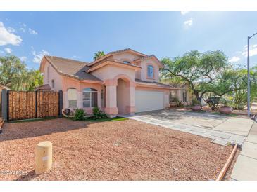 Charming two-story home featuring a well-manicured lawn, desert landscaping, and an attached two-car garage at 6219 W Navajo Dr, Glendale, AZ 85302