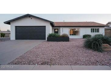 Charming single-story home featuring a two-car garage and desert landscaping at 8637 E Mulberry St, Scottsdale, AZ 85251