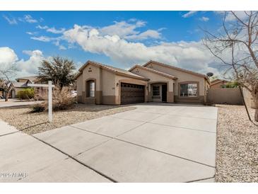 Charming single-story home with a well-maintained front yard and an attached two-car garage at 9325 W Elwood St, Tolleson, AZ 85353