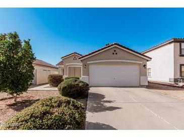 Charming single-story home with a well-maintained front yard and a two-car garage at 977 E Saratoga St, Gilbert, AZ 85296