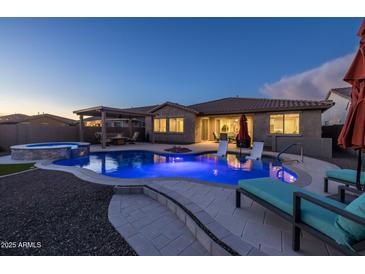 Inviting backyard pool with lounge chairs, covered patio, and a relaxing spa, perfect for outdoor enjoyment at 10547 E Relativity Ave, Mesa, AZ 85212