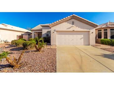 Charming single-story home featuring a two-car garage and desert landscaping for low maintenance appeal at 11029 W Oraibi Dr, Peoria, AZ 85373