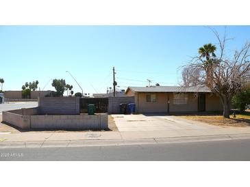 Single-story home featuring a low-maintenance desert landscape and long driveway at 1209 W 1St Pl, Mesa, AZ 85201