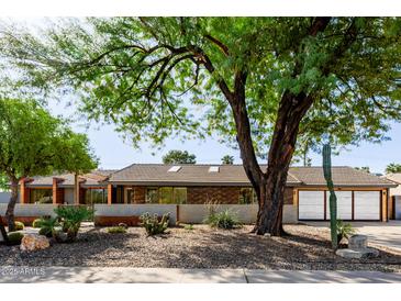 Charming single-story home featuring desert landscaping, modern architecture, and a private two-car garage at 1755 W Lawrence Ln, Phoenix, AZ 85021