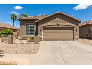 Charming single-story home featuring a two-car garage and desert landscaping at 20840 E Vía Del Palo --, Queen Creek, AZ 85142