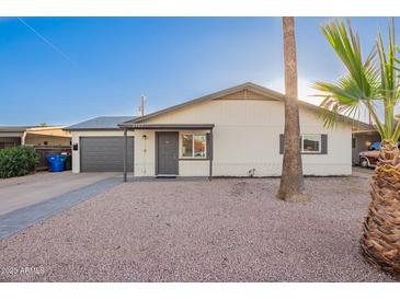 Charming single-story home with a well-manicured front yard and attached garage at 2301 E Alpine E Ave, Mesa, AZ 85204