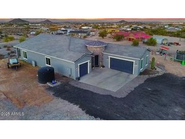 Stunning home boasts a circular stone entryway and a large, two-car garage at 3002 W Josiah Trl, Queen Creek, AZ 85144