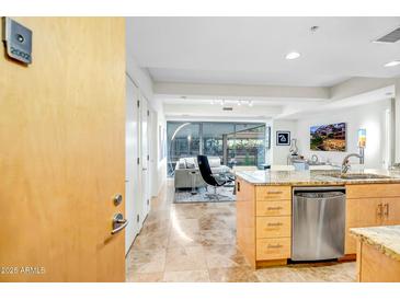 Open-concept kitchen featuring a large island with granite countertops and stainless steel appliances at 7121 E Rancho Vista Dr # 2002, Scottsdale, AZ 85251