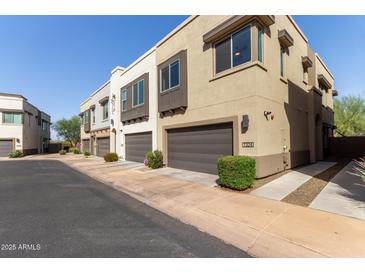 A row of modern townhomes featuring neutral colors, individual garages, and well-maintained landscaping at 7324 E Vista Bonita Dr, Scottsdale, AZ 85255