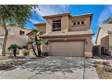 Two story home with a two car garage, tile roof, and desert landscaping at 1054 S Butte Ln, Gilbert, AZ 85296