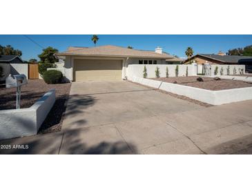 Charming home exterior featuring a spacious driveway and well-maintained desert landscaping at 120 W Thunderbird Rd, Phoenix, AZ 85023