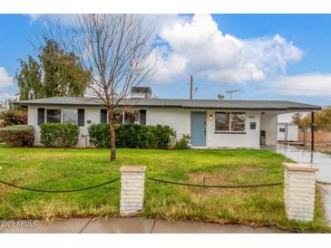 Charming single-story home features a well-maintained front yard with privacy landscaping and a covered front entry at 14608 N Montego Ct, Phoenix, AZ 85053