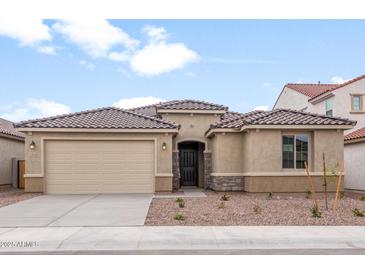 Inviting one-story home featuring a two-car garage and a tile roof at 17614 W Rancho Dr, Litchfield Park, AZ 85340