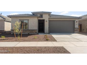 Charming single-story home features a stucco exterior, stone accents, and a well-maintained front yard at 17845 W Getty Dr, Goodyear, AZ 85338