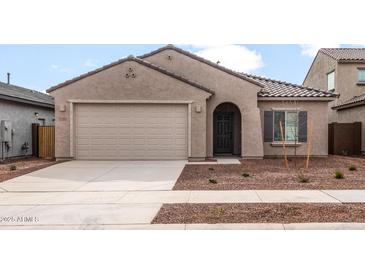 Charming single-story home featuring a two-car garage and low maintenance desert landscaping at 17851 W Getty Dr, Goodyear, AZ 85338