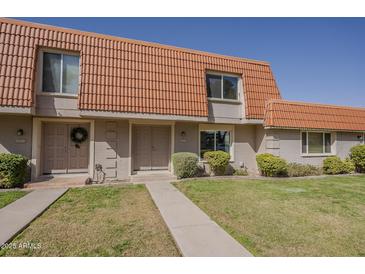 Charming townhome with a well-manicured front yard and a classic red tile roof at 5112 N 83Rd St, Scottsdale, AZ 85250