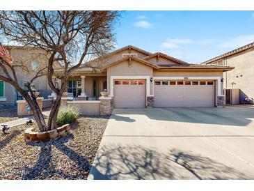 Charming single-story home featuring a well-manicured front yard and a spacious two-car garage at 8385 W Vogel Ave, Peoria, AZ 85345