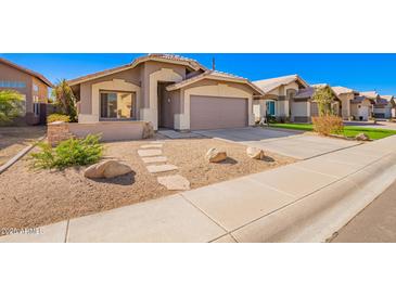 Charming single-story home with a xeriscaped front yard and neutral earth tone color palette at 1421 E Gary Dr, Chandler, AZ 85225