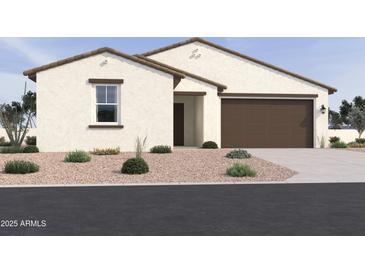 Charming single-story home featuring a two-car garage and low-maintenance desert landscaping in front at 15781 W Cheryl Dr, Waddell, AZ 85355