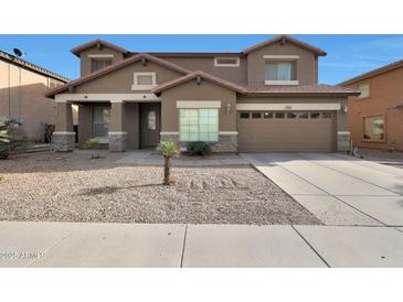 Charming two-story home with a desert landscape and an attached two-car garage at 3111 W Pleasant Ln, Phoenix, AZ 85041