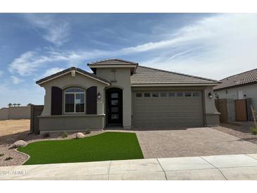 Charming single-story home features a neatly landscaped yard and a two-car garage at 34825 N Kaden Rd, San Tan Valley, AZ 85144