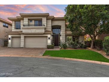 Stunning two-story home with a three car garage, lush landscaping, and a beautiful arched entry way at 6508 N 28Th St, Phoenix, AZ 85016