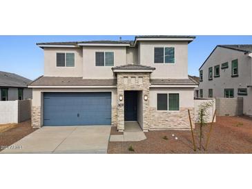 Charming two-story home featuring a blue garage door, stone accents, and a well-maintained front yard at 7400 W Quail Track Dr, Peoria, AZ 85383