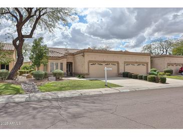 Charming single-story home with a two-car garage, beautiful landscaping, and neutral color palette at 8347 W Taro Ln, Peoria, AZ 85382