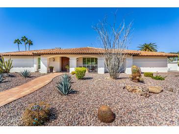 Charming single-story home featuring a desert landscape, walkway and barrel tile roof, and covered front porch at 9234 N 33Rd Way, Phoenix, AZ 85028