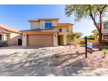 Charming two-story home with a well-maintained front yard and a spacious two car garage at 9413 W Pioneer St, Tolleson, AZ 85353