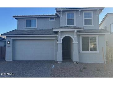 Charming two-story home with gray stucco, a two-car garage, and manicured landscaping at 10865 E Tiburon Ave, Mesa, AZ 85212