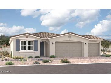 Charming single-story home featuring a neutral-colored exterior, tile roof, three-car garage, and low-maintenance landscaping at 12370 W Marguerite Ave, Avondale, AZ 85323