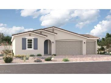 Charming single-story home featuring a three-car garage, neutral paint, brick driveway, and low-maintenance desert landscaping at 12374 W Marguerite Ave, Avondale, AZ 85323