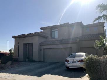 Contemporary two-story house featuring a three-car garage and a well-maintained front yard at 14435 W Verde Ln, Goodyear, AZ 85395