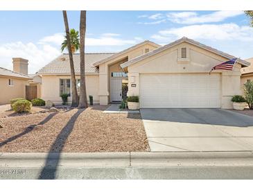 Inviting single-story home featuring a two-car garage, desert landscaping, and neutral color palette at 15377 W Cheery Lynn Rd, Goodyear, AZ 85395